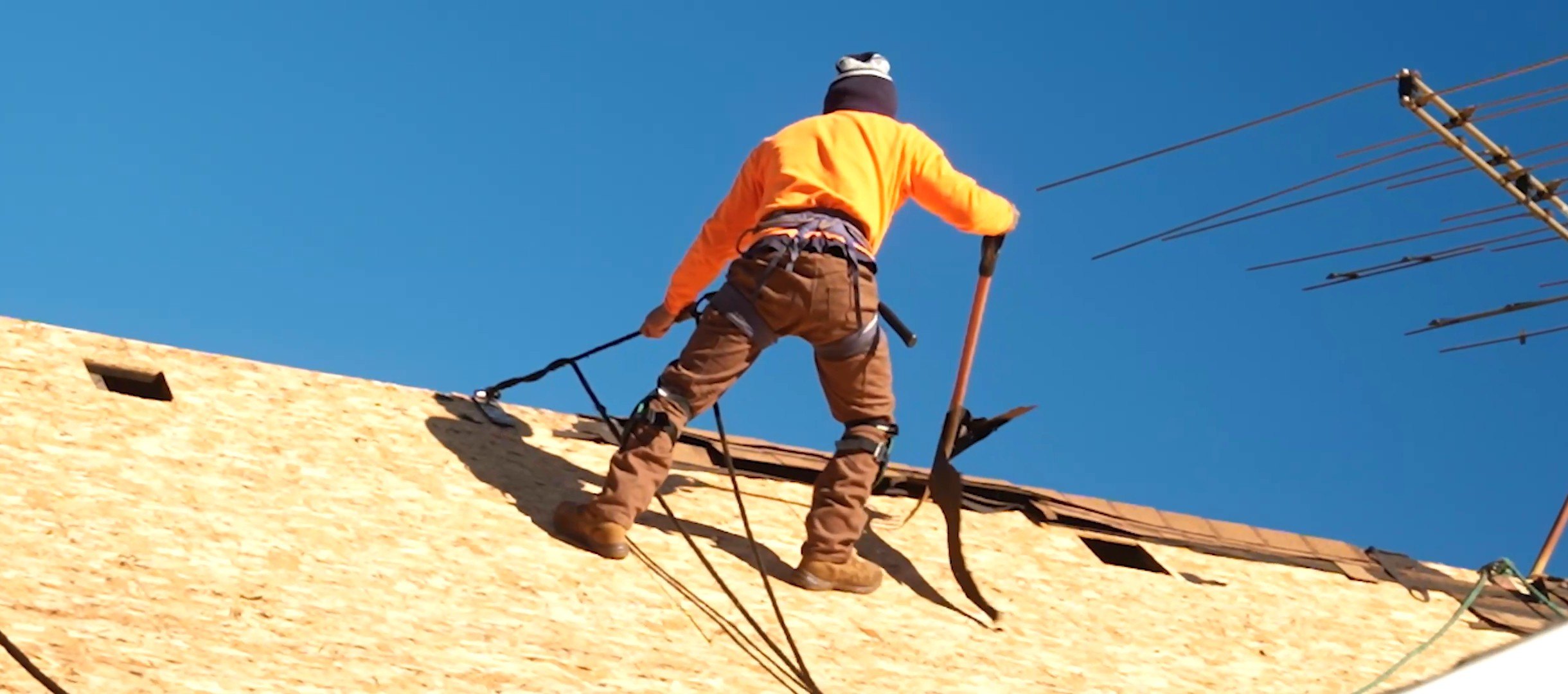 A Roof X Solutions roofer tearing off shingles on a Jonesboro home